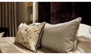 Grey long cushions on bed