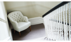 White upholstered nursing chair with arms