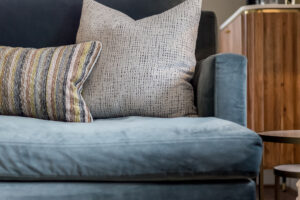 textured natural colour cushions on a blue sofa