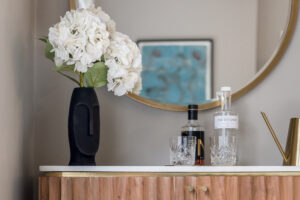 living room vanity until with matching gold circular mirror
