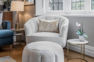 luxury armchair and footstool with mustard leaf cushion