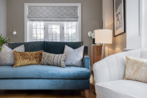modern living room with blue sofa and white armchair
